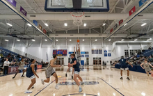 Adidas Davis attempting three-point shot on UIS basketball court