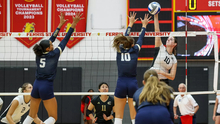 UIS Volleyball players go up for a block