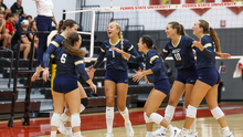 UIS Volleyball team celebrating on court at Ferris State tournament