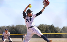 Rosie Bartletti pitching in white uniform