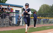 Jaden Watts running home in a softball game