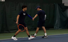 Lin En Tan and Pablo Herrera high five during doubles match