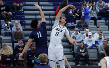 Donaven Younger jumping during tip-off at home UIS basketball game