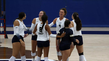 Volleyball huddle including Kaitlyn Taylor