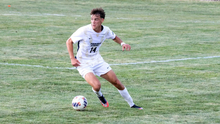 Liam McLean playing soccer in white UIS jersey