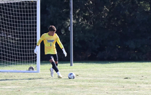 UIS goalkeeper Kevin Kardel kicks ball, yellow jersey