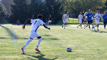 Gentil Selemani bringing ball up field in a UIS soccer game