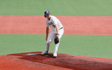 Ben Benoit pitching in white UIS uniform