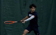 Lin En Tan playing tennis in UIS uniform