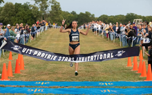 Madelyn Miller-Ross crosses finish line at cross country meet