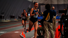 Madelyn Miller-Ross racing in blue UIS uniform at GLVC Indoor Championship