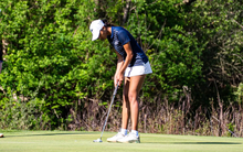 Ira Joshi golfing in UIS blue and white
