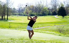 Lia Rody golfing in blue UIS gear