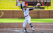 Rosie Bartletti pitching in white uniform in GLVC Tournament