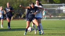 Alaina Stock playing soccer in blue UIS uniform