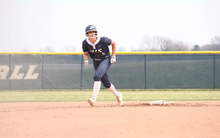 Bailey Masching baserunning in blue UIS softball uniform