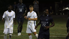 Carter Downen and Gentil Selemani on soccer field