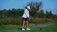 Valentina Torralba golfing in UIS white and blue