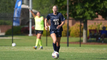 Abby Roy playing soccer in blue UIS uniform