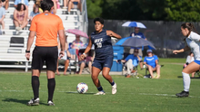 Ellie Mejia playing soccer in blue UIS uniform