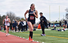 Allison Thompson running track in blue UIS uniform