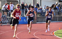 River Derby running outdoor track in blue UIS uniform