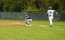 Drew Ezard playing first base in blue UIS baseball uniform