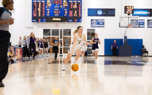 Julia Mingus dribbles down the court