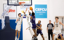 Isaiah Davis goes up for a block in men's basketball