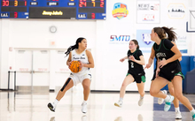 Kayla Rice playing basketball in white UIS uniform