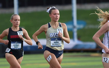 Maddie Miller-Ross running track in gold UIS uniform