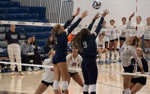 UIS volleyball players blocking