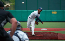 Esteban Hernandez pitching in white UIS uniform