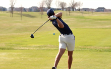 Julien Babineau playing golf in blue UIS polo