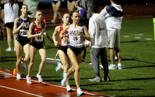 Maddie Miller running outdoor track in UIS uniform