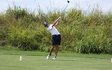 A photo of Jake Balding golfing in a white polo and blue hat