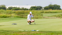 Jacob LeBlanc golfing in white UIS polo and hat