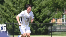 Jacob Shaw playing soccer in white UIS uniform