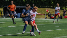 Josh Mensching playing soccer in blue UIS uniform
