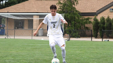 Lennard Borgs playing soccer in white UIS uniform