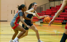 Molly Knight playing basketball in blue UIS uniform