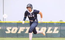 Rachel McMullen running the bases in blue UIS softball uniform