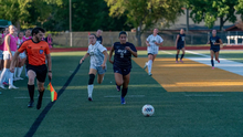 Reese Lowery playing soccer in blue UIS uniform
