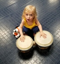 young girl plays the drums