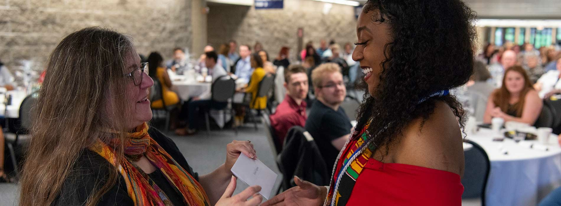 student getting honors cords
