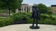 Abraham Lincoln statue on campus is in the foreground and the colonnade is in the background