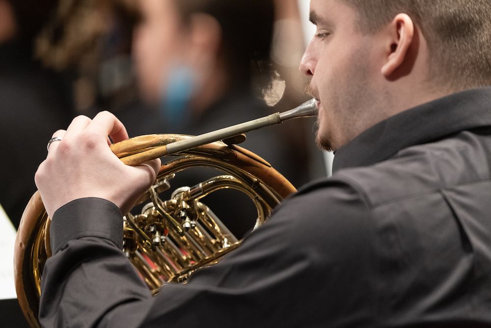 man playing a french horn