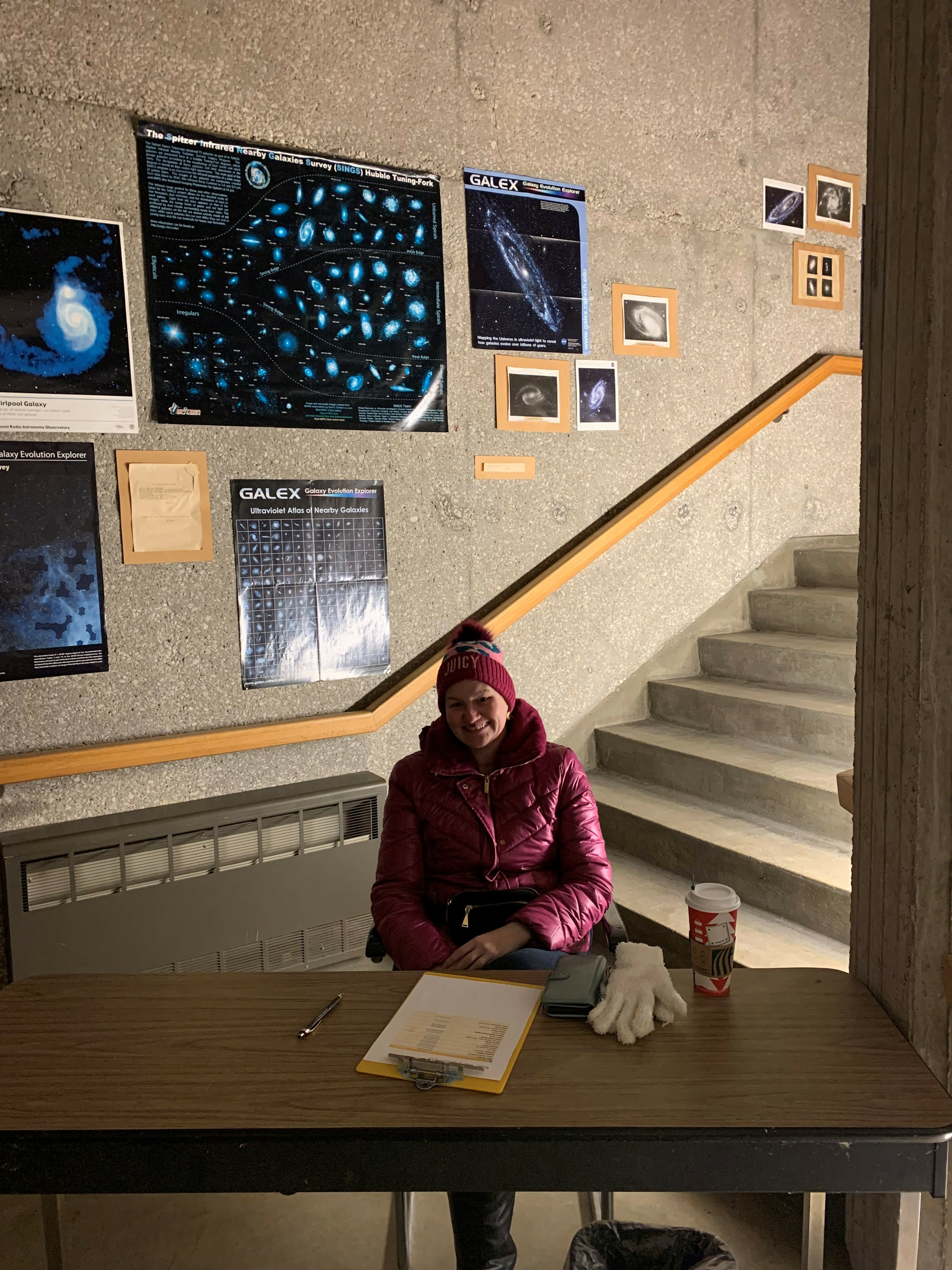 Person sitting at a registration table at the entrance to the UIS Observatory stairwell. stairwell.