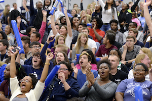students wildly cheering on the bleachers