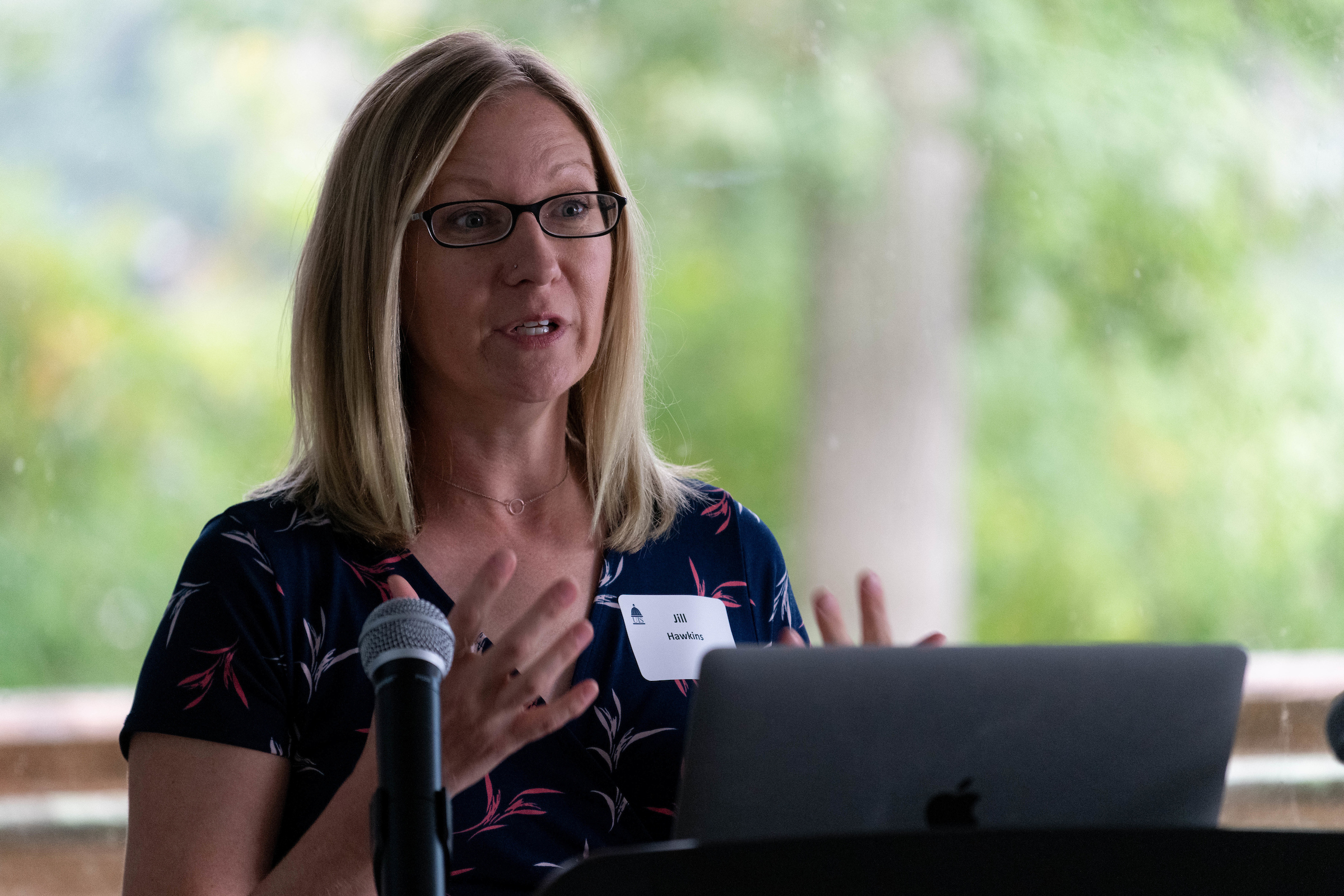 A female speaking at a podium